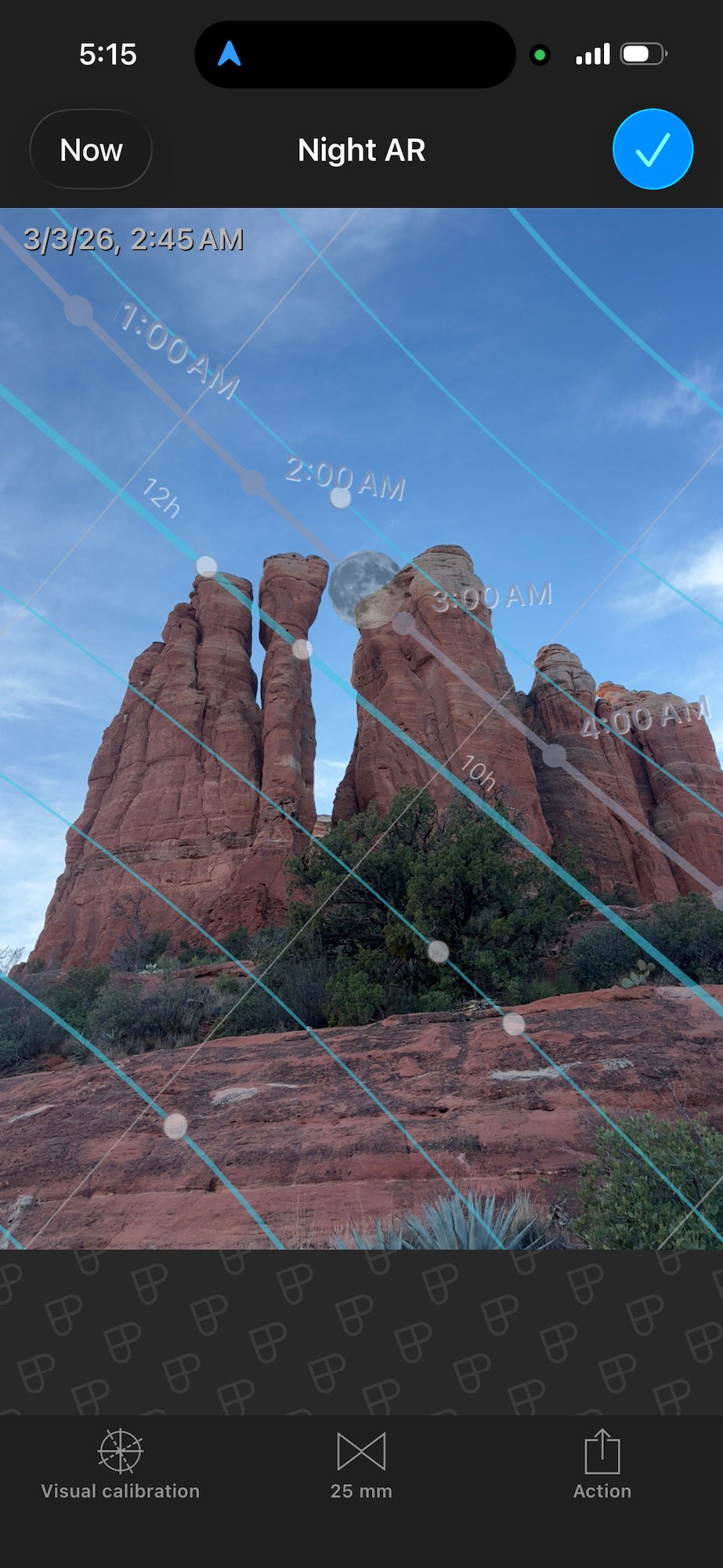 Augmented reality overlay predicting the moon&rsquo;s path across sandstone spires before dawn.