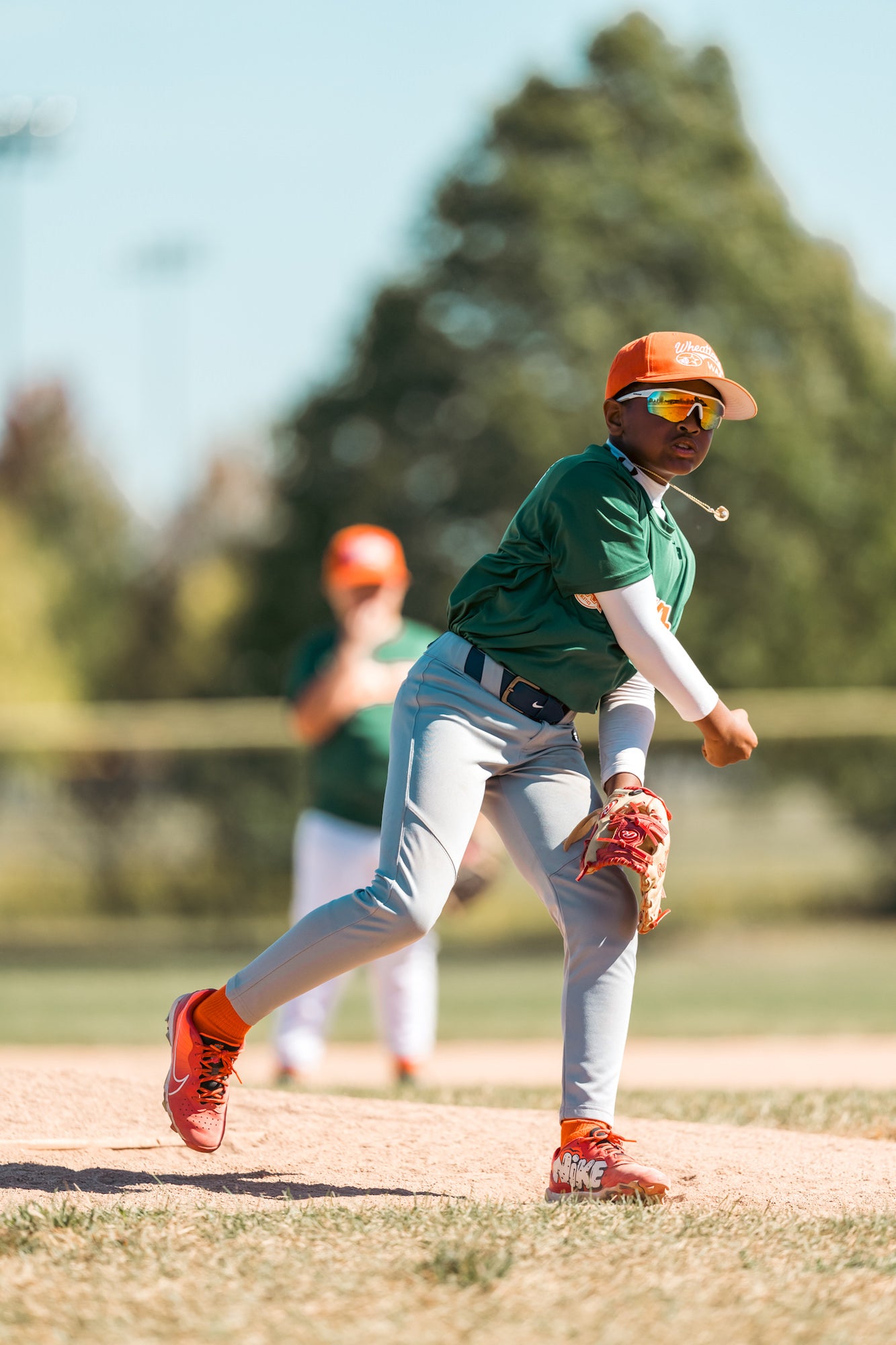 Pitcher follows through after the throw, glove hand low and body rotating toward home. Pitcher follows through after the throw, glove hand low and body rotating toward home.