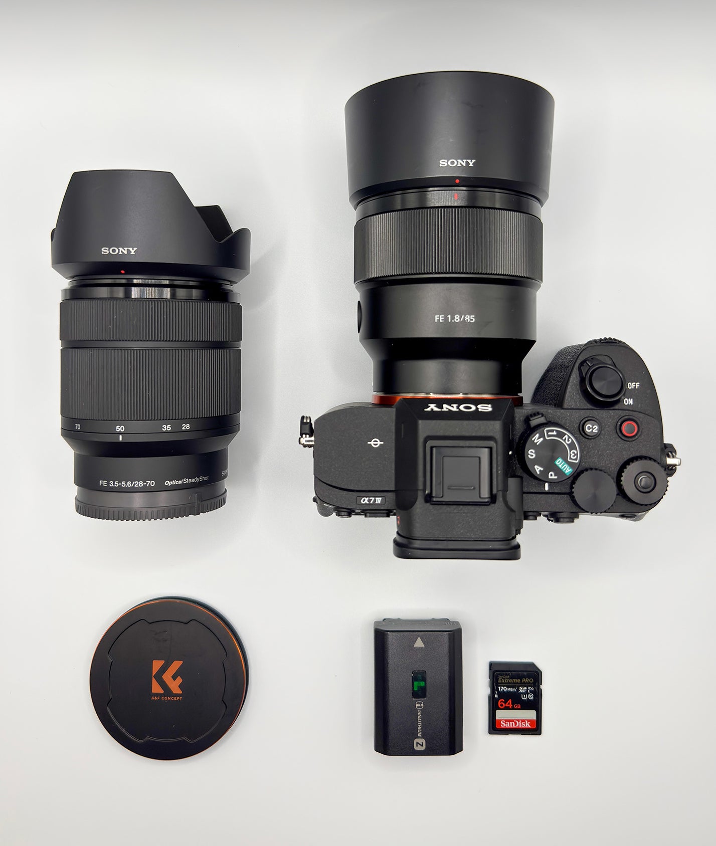 Sony Alpha camera with 85mm, 28–70mm lens, battery and SD cards arranged for a what’s in my bag feature. Sony Alpha camera with 85mm, 28–70mm lens, battery and SD cards arranged for a what’s in my bag feature.